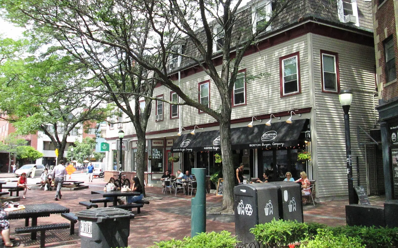 Davis Square in Somerville, with outdoor tables under the trees